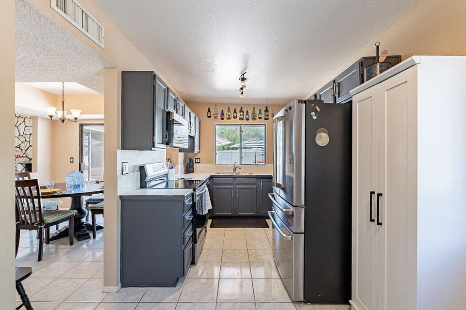 Well-equipped kitchen with stainless steel appliances and view of the backyard