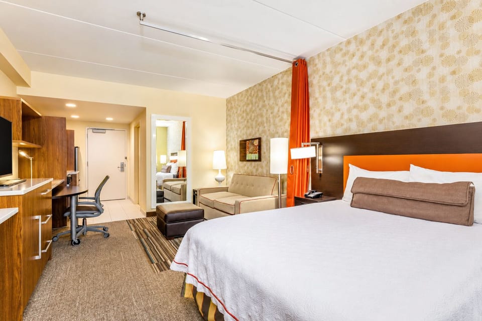 Unwind in a bright, spacious suite with plush king bed.