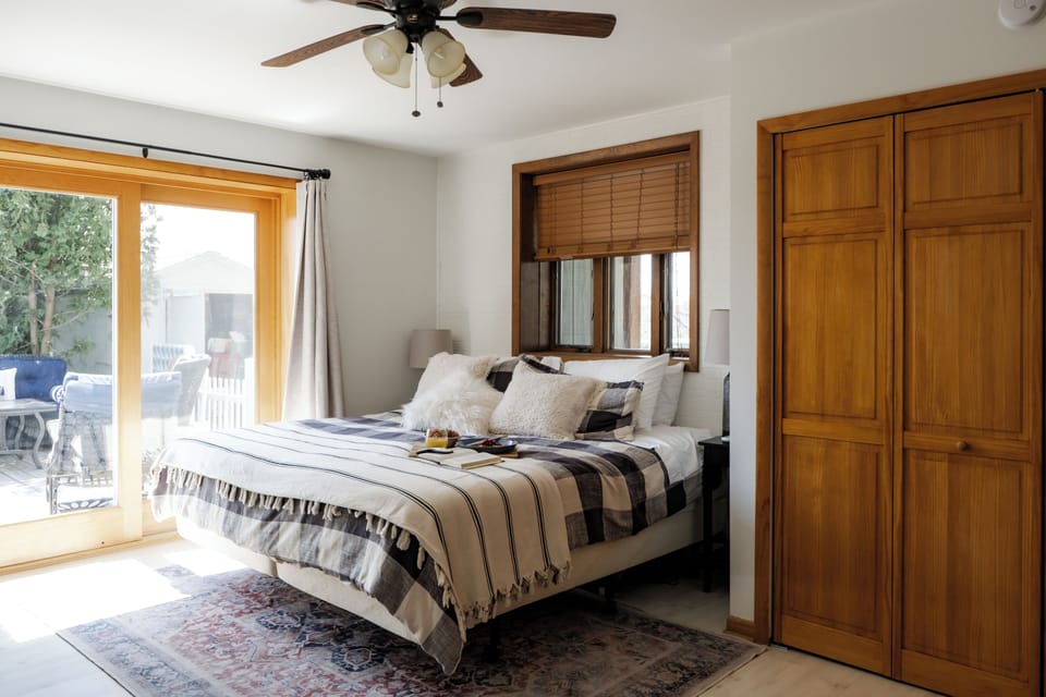 1 of 2 Master bedrooms! This Master has a king size Tempur-Pedic  bed with the ability for each person to adjust their side of the bed. There is a small, private ensuite bathroom plus access to the back patio!