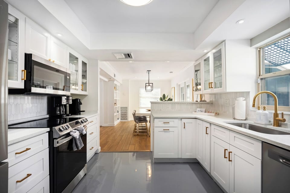 Bright modern kitchen with stylish finishes and open dining flow