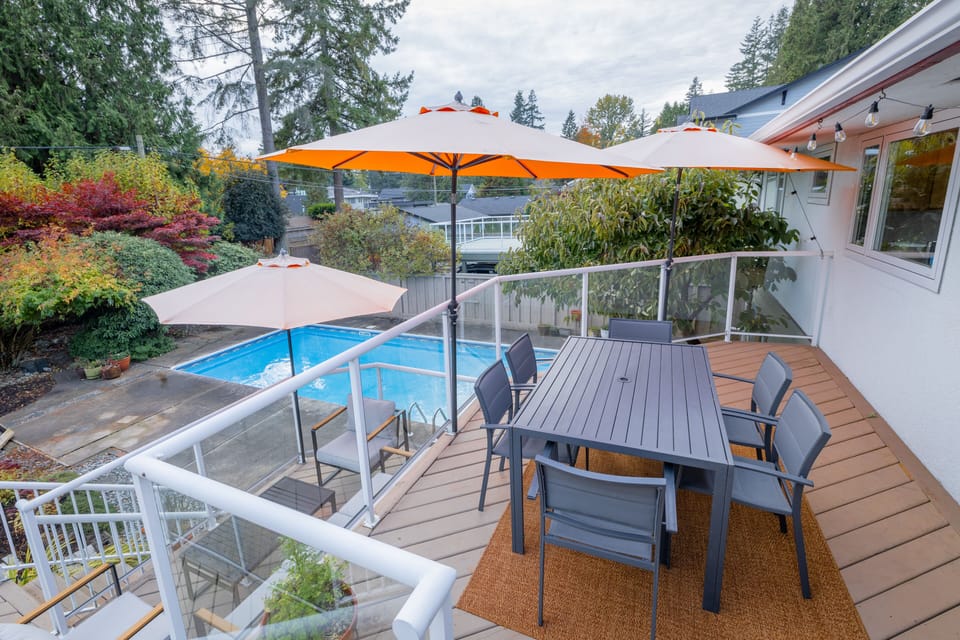 View to large heated pool from patio deck outdoor dining area