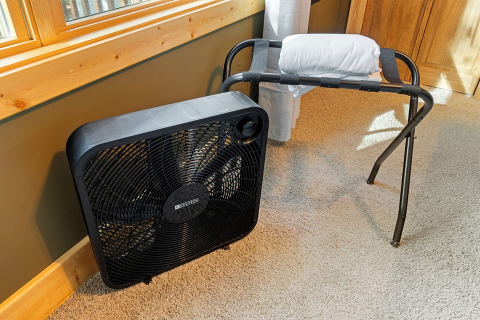Each cozy bedroom has a box fan, luggage rack, and extra sheets