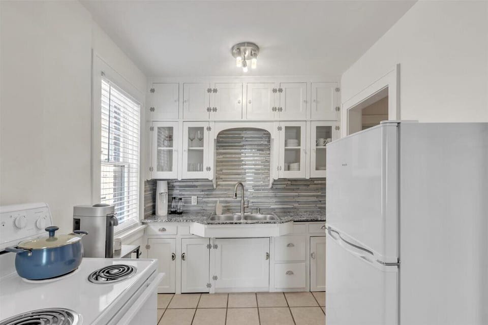 Kitchen has a refrigerator, electric stove, oven, Nespresso & Soda Stream.