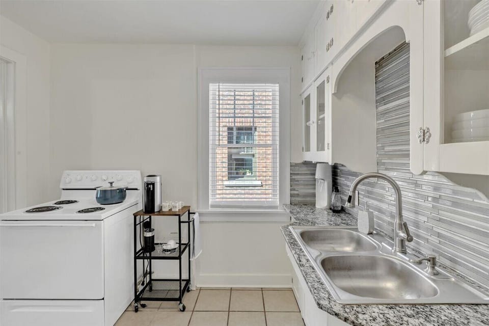 Fully stocked kitchen with electric range for cooking.