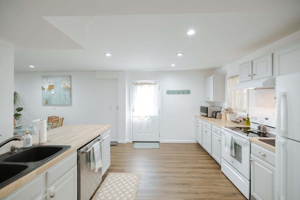 Spacious kitchen with full appliances, cookware, spices, and essentials.