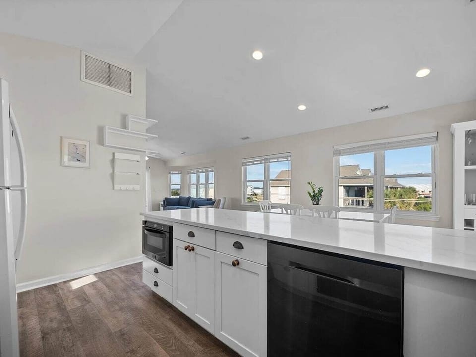 Cook with ease in the fully updated kitchen featuring modern appliances, induction stovetop, cookware, coffee maker, and everything needed for preparing meals at home