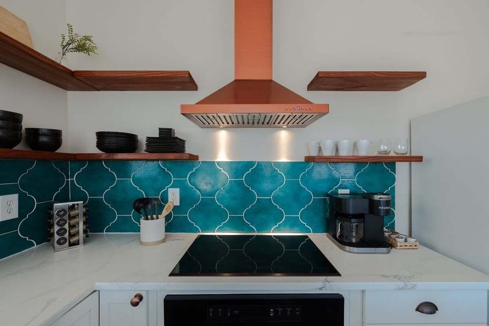 Cook with ease in the fully updated kitchen featuring modern appliances, induction stovetop, cookware, coffee maker, and everything needed for preparing meals at home