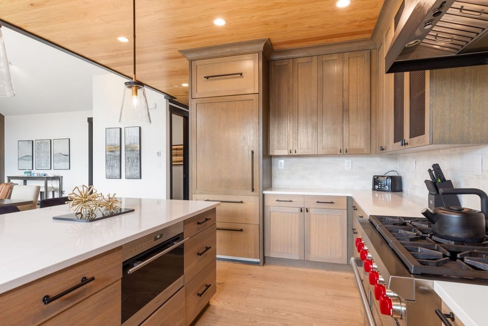 Your chef-ready kitchen features warm wood cabinetry, gleaming quartz countertops, and professional-grade appliances—perfect for crafting memorable meals in style.