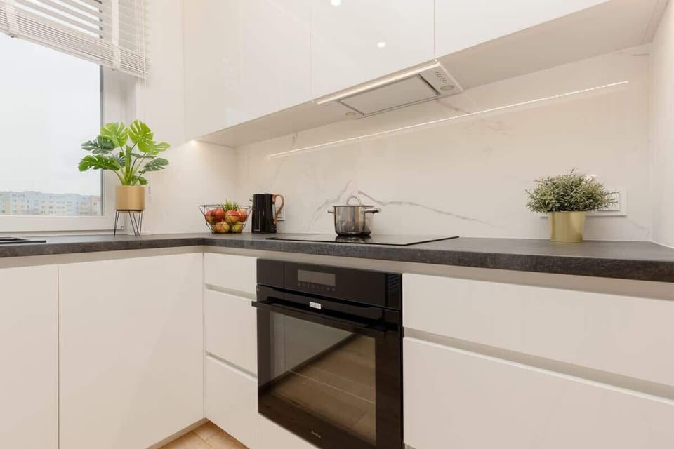 The sleek design of the kitchenette blending seamlessly with the living area.