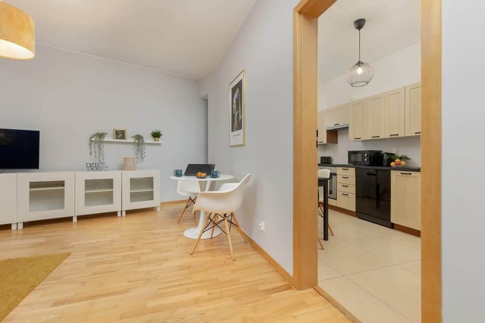 A bright dining area connected to the living room, showcasing a harmonious flow and contemporary design.

