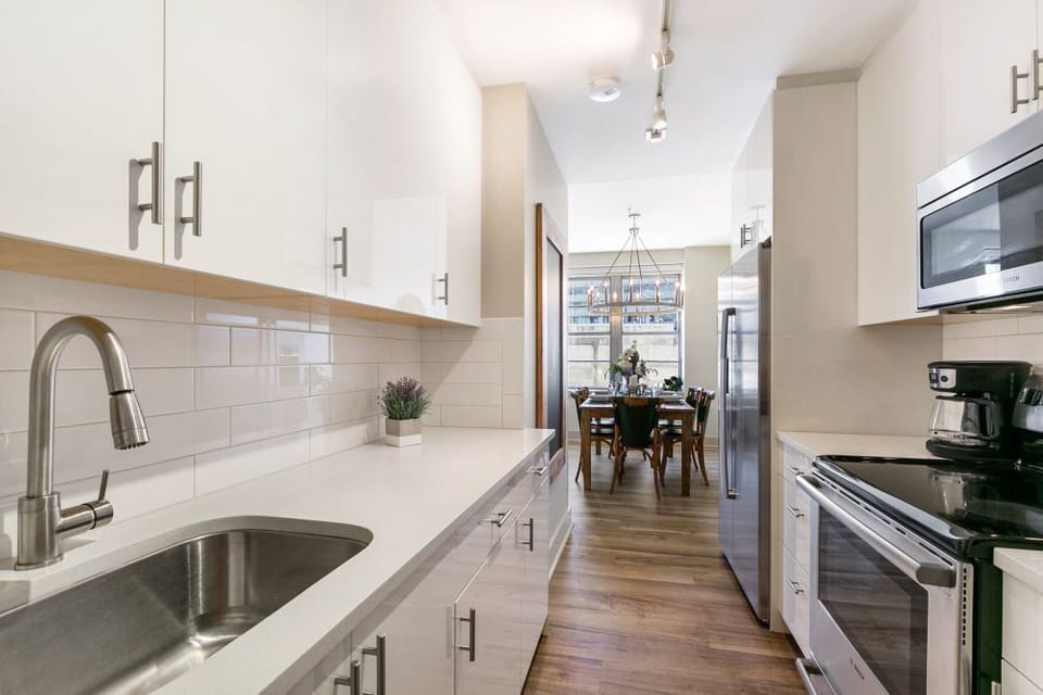 Beautiful clean white kitchen leads right to the dining area