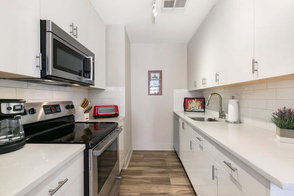 Creating Culinary Magic in Our Full Kitchen Wonderland with Stainless Appliances and Quartz Countertops
