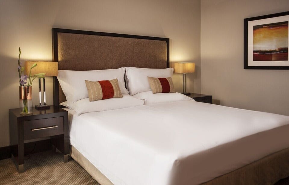 Drift off in a serene bedroom with soft lighting.