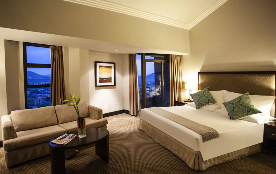 Unwind in a spacious suite with cozy seating and night views.
