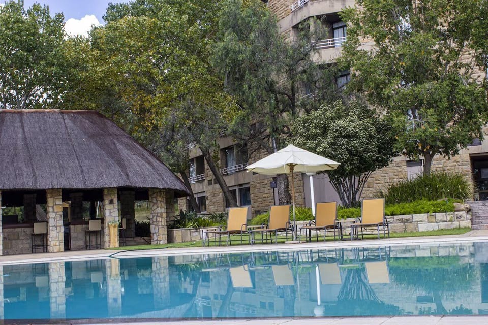 Sip and socialize near the pool with shaded gathering spots.