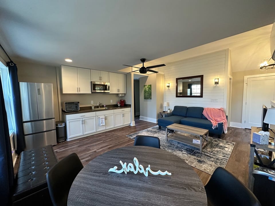 Open living space with comfortable sofa that features a full-size bed.