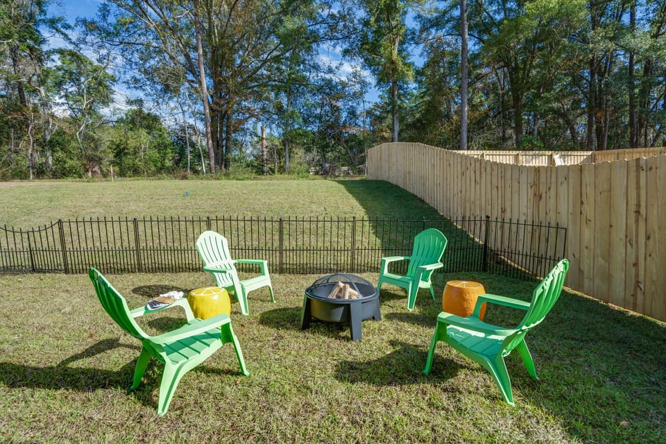 Patio for four with Adirondack chairs and fire-it in a large fenced lawn