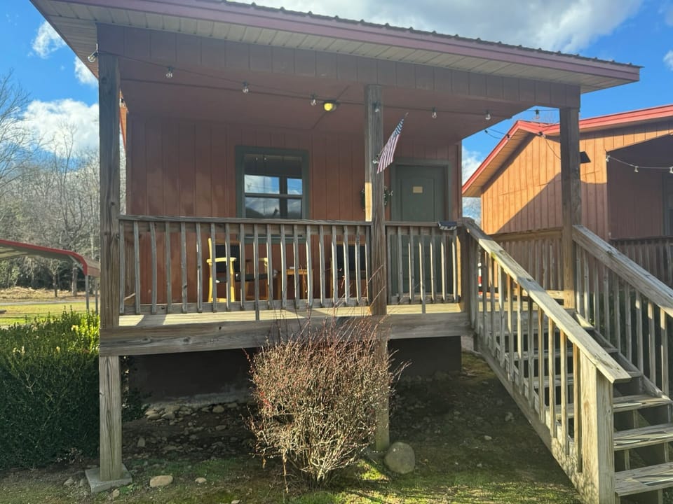 Each Cabin offers an inviting front porch with seating to enjoy the view