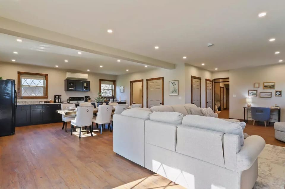View of kitchen-dining-living room, full bathroom, coat closet and desk 