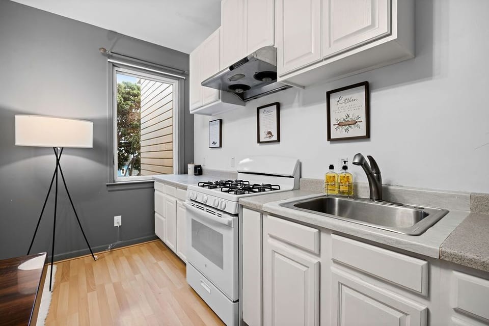 Kitchen with breakfast bar, pendant lights, and stainless steel appliances