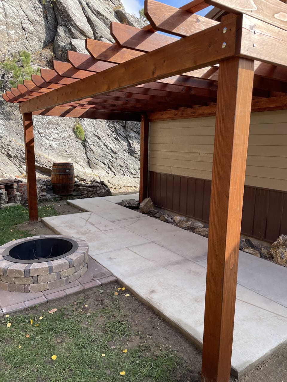 Pergola with fire pit on the side.