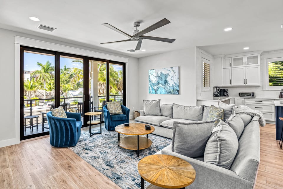 2nd Level Living Room with kitchen and balcony view.
