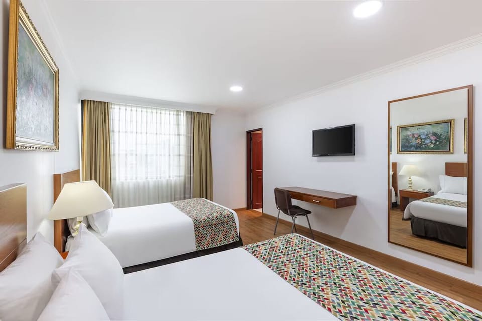 Stretch out in a bright room with TV and workspace.