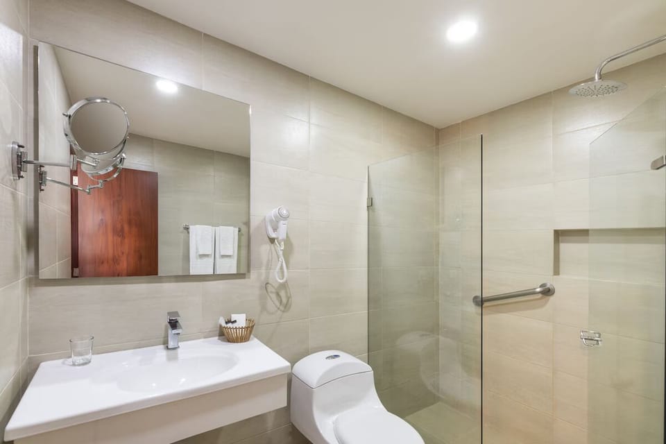 Refresh under a rainfall shower in a spotless modern bath.