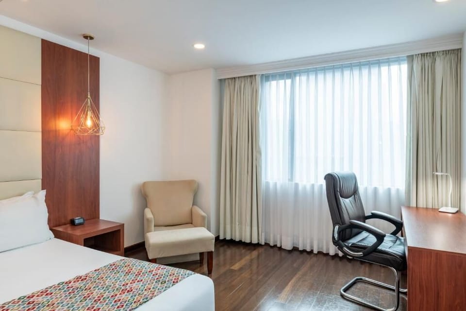 Unwind by the window, then catch up at the desk.