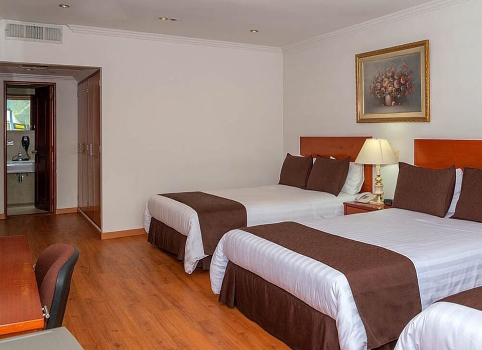 Unwind in twin beds with warm lighting and quiet comfort.