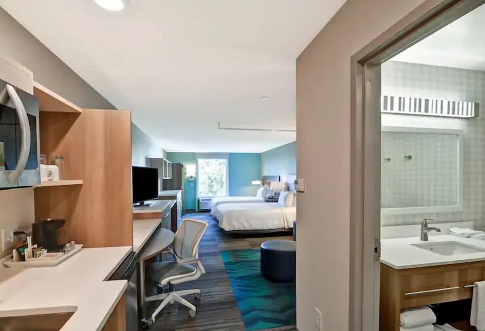 Settle in with a roomy layout, desk, and easy comfort.