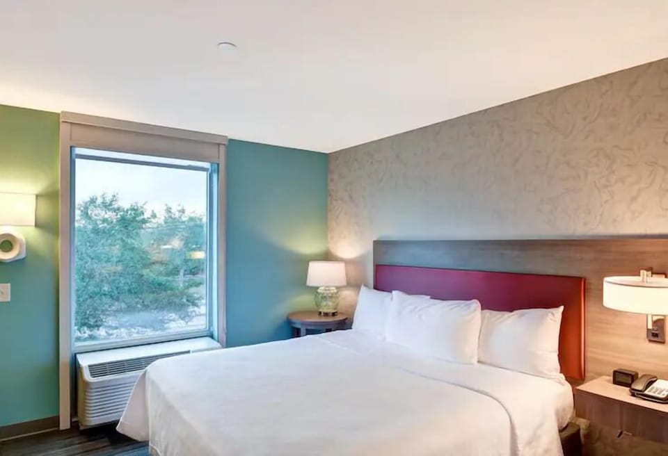 Unwind in a sunlit bedroom with crisp, hotel-fresh linens.
