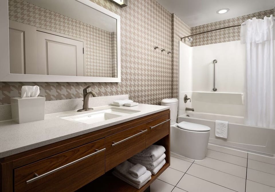 Refresh easily with a bright vanity and shower-tub combo.