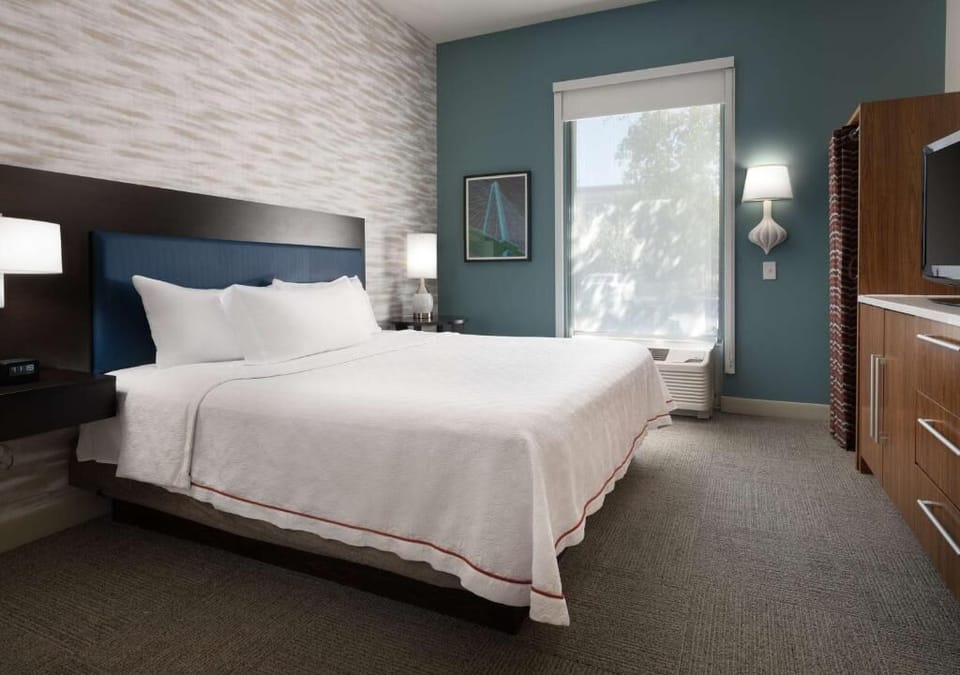 Stretch out on a plush bed with warm bedside lighting.