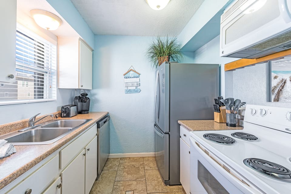 Prepare your favorite meals in this bright, fully-equipped kitchen with modern appliances and cheerful coastal touches.