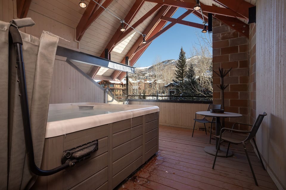 Unwind in your private hot tub while soaking in stunning mountain views from this covered terrace.