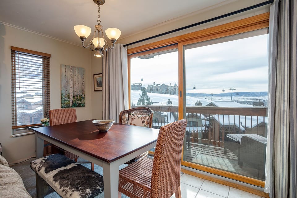 Enjoy meals with stunning lake and mountain vistas from your dining space, where panoramic windows frame the scenery perfectly.