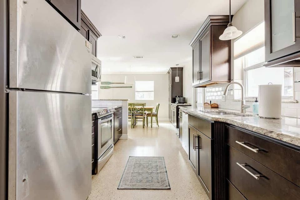 Fully equipped galley kitchen with granite countertops and stainless steel appliances.