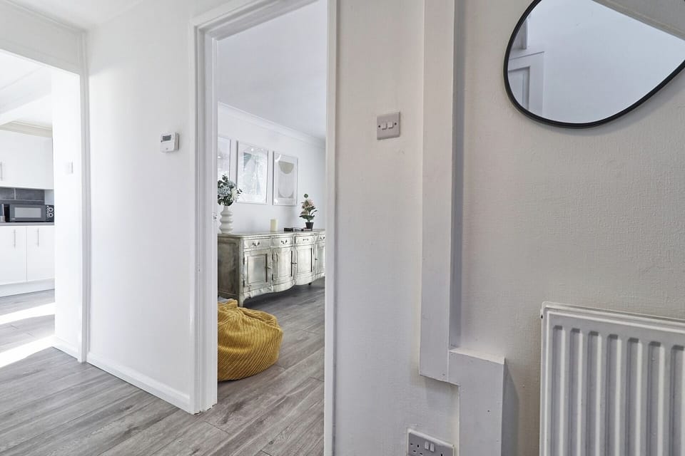 The hardwood floors connect the bright spaces together elegantly