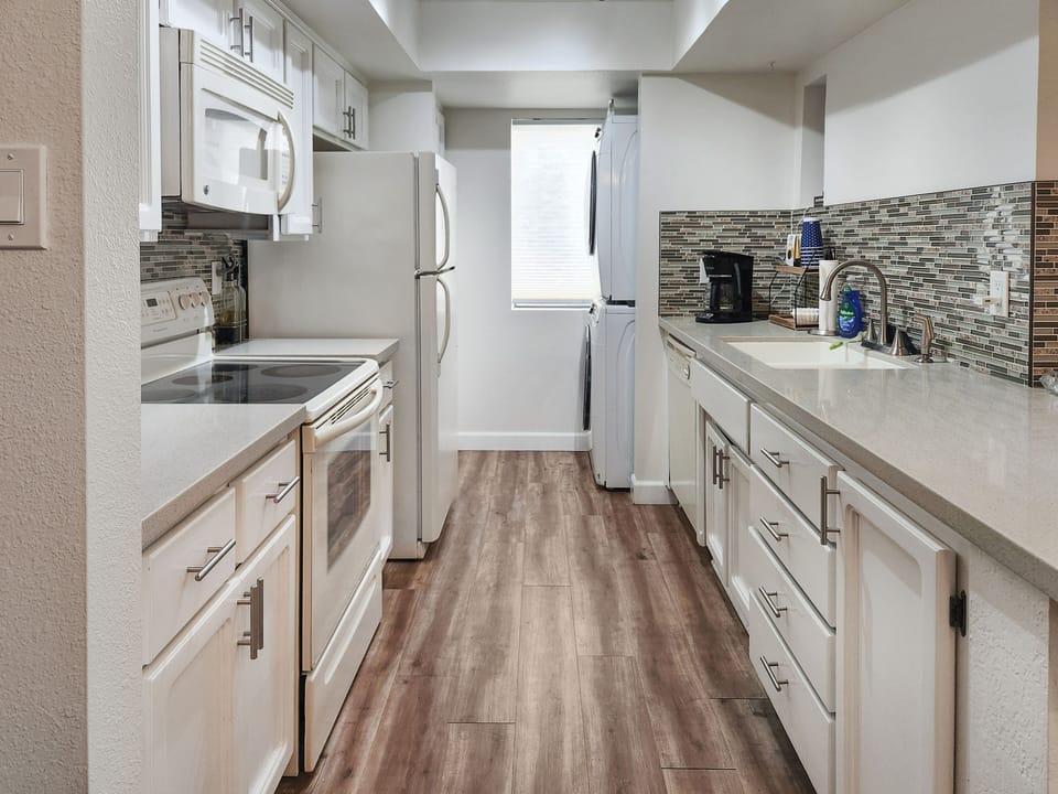Spacious fully stocked kitchen with stacked full size washer/dryer
