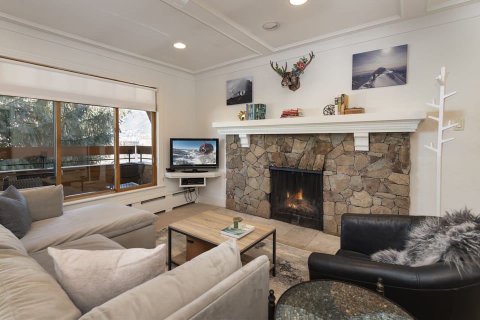 Wood fireplace warms the beautiful natural light in the  living area.