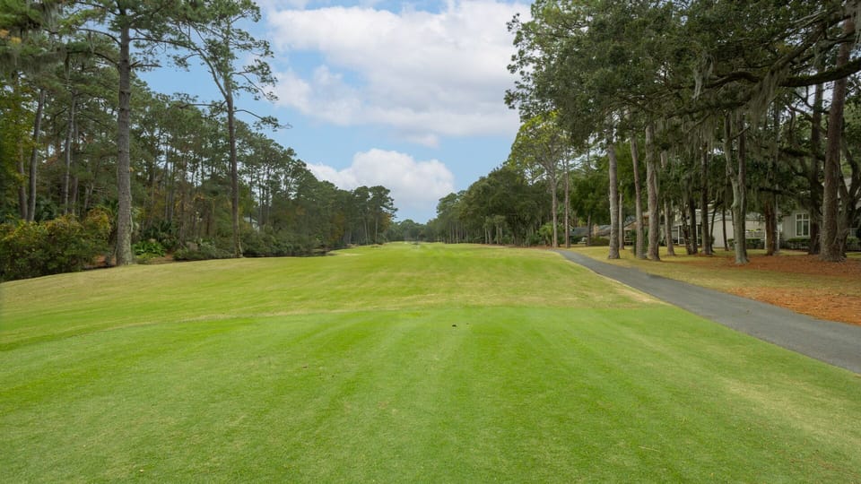 A wide driveway provides easy parking, while the welcoming front entry features large picture windows that fill the home with natural light.