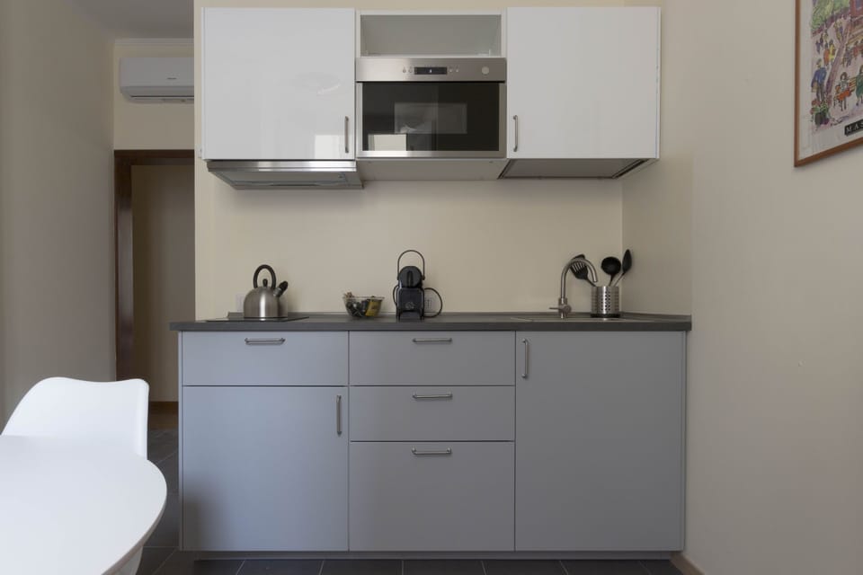 Kitchen with induction hobs, microwave oven, boiler and Nespresso machine