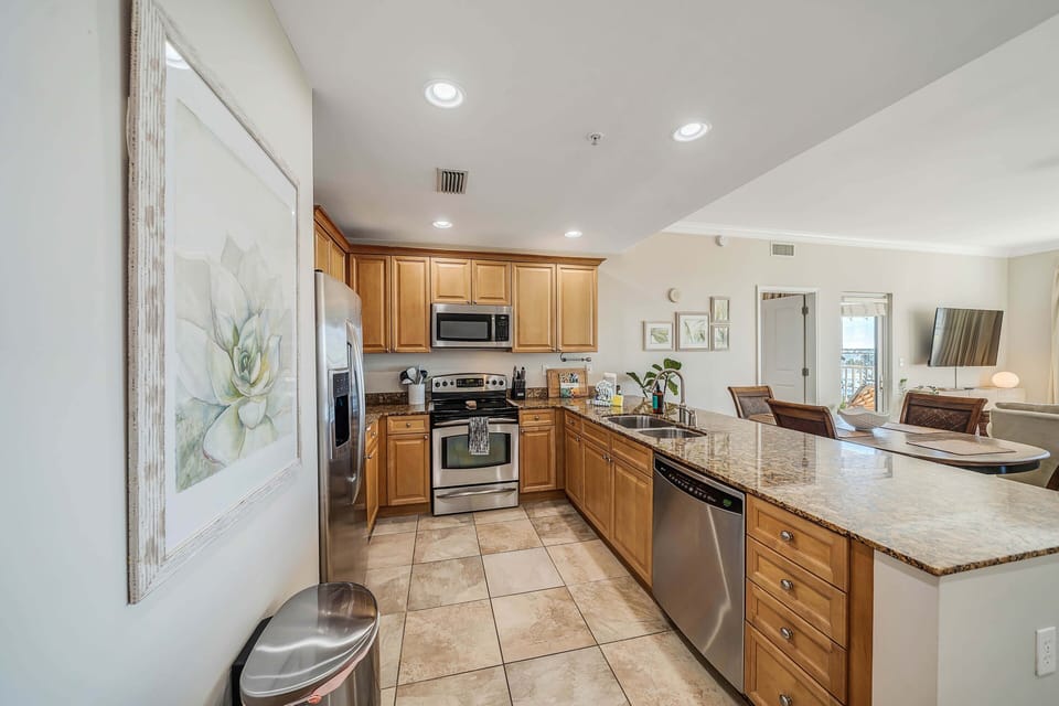 The fully equipped kitchen features granite countertops, stainless-steel appliances, and has everything you need to enjoy meals with family and friends.