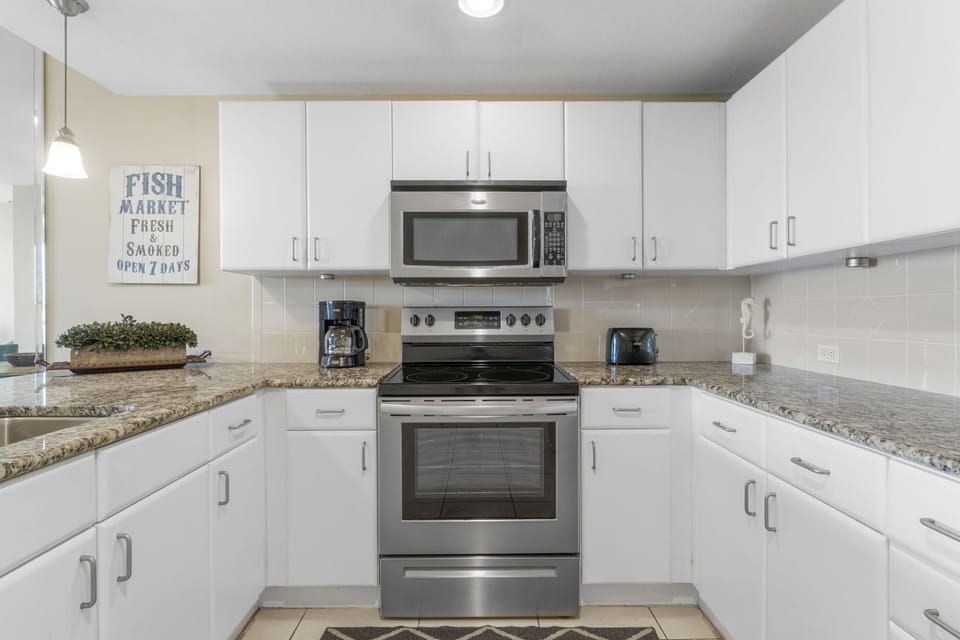 Modern kitchen with stainless steel appliances and granite countertops