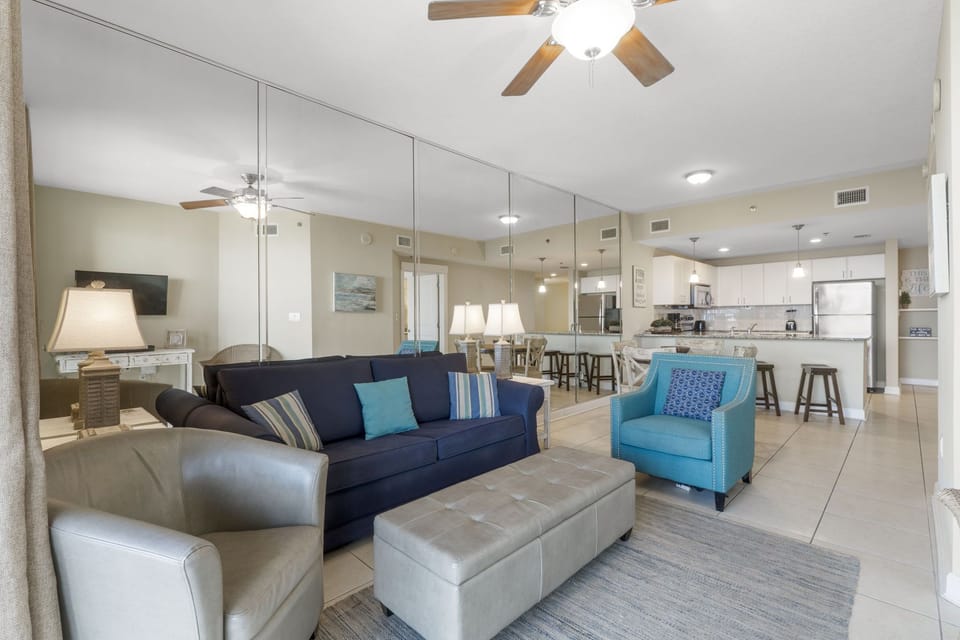 Open living area with modern seating and mirrored wall enhancing space.