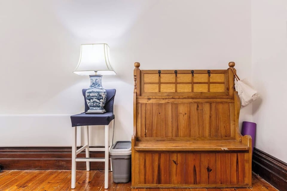 As you walk through the door, you'll be greeted by an antique entryway bench, adding a touch of timeless charm to your stay.