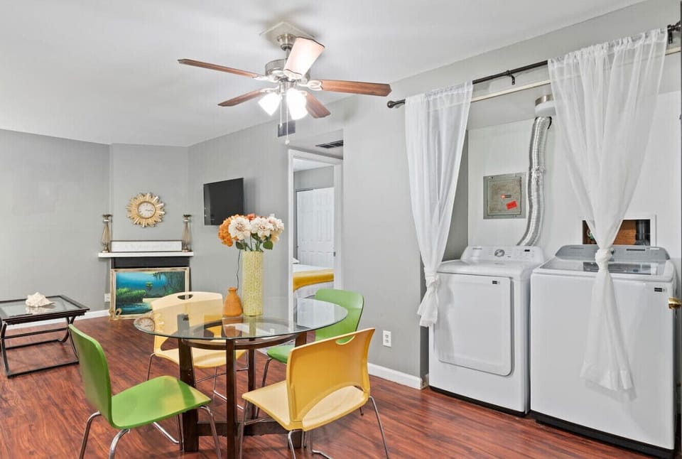 Elegant glass countertop table accompanied by brightly colored chairs, forming an inviting environment to relish your meals. Whether you`re enjoying your favorite TV show while dining or preparing your meals, the experience is yours to sav