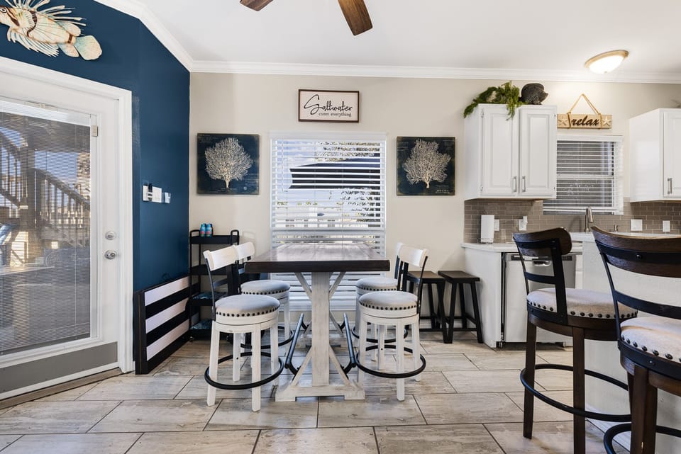 Dining area has a view of the pool and canal. Pool towels and sun accessories.