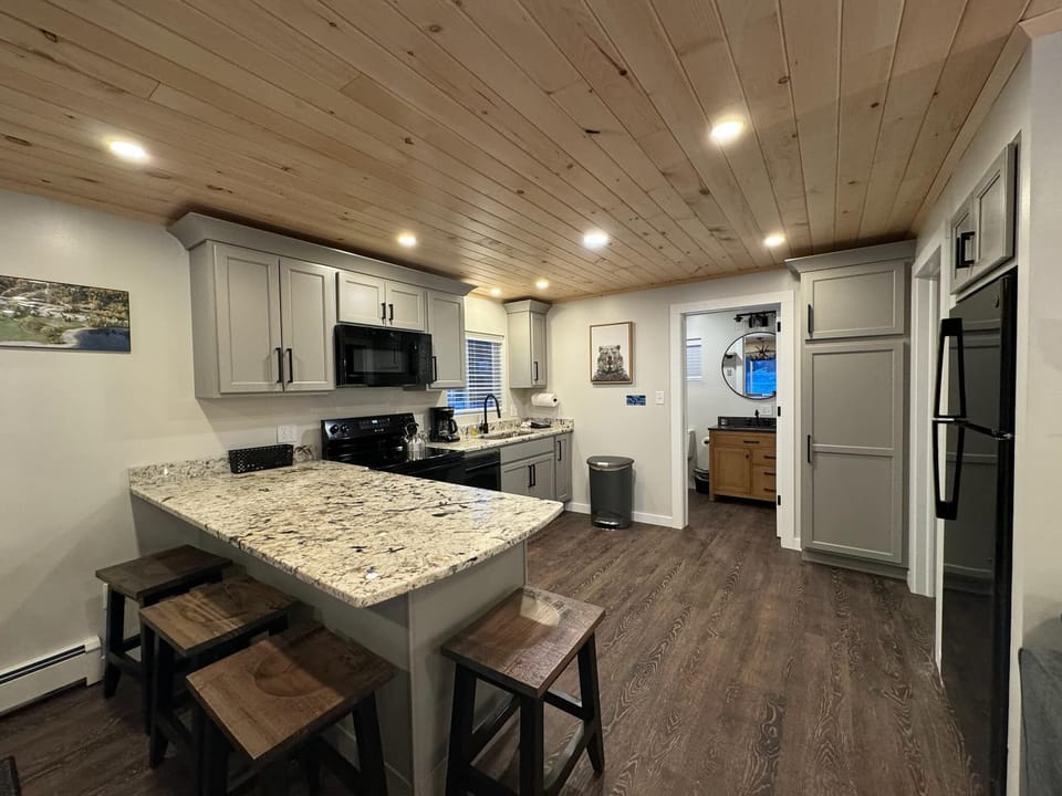 Fully equipped kitchen with a stove, microwave, toaster, and coffee maker